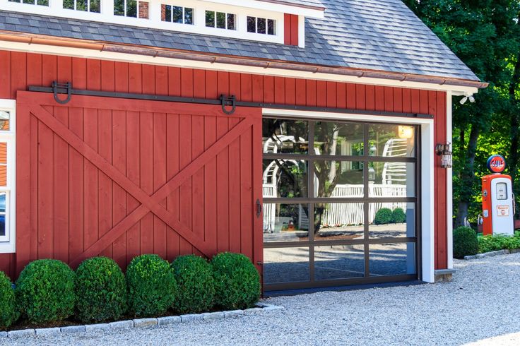 a red barn with an open garage door