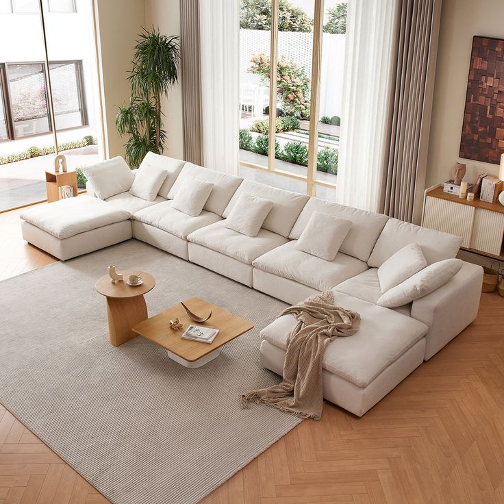 a living room with a large white sectional couch