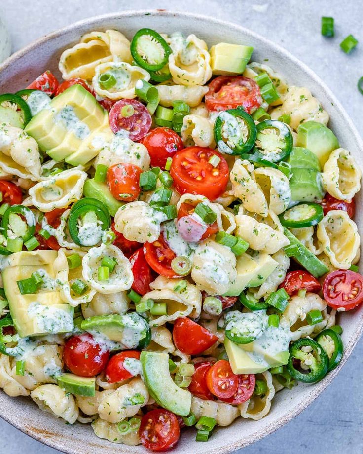 a bowl filled with pasta salad on top of a table