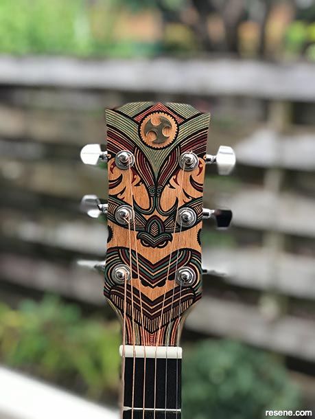 a close up of an acoustic guitar's neck and fret cover with designs on it