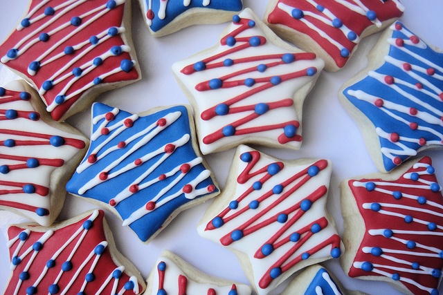 decorated cookies with red, white and blue icing are arranged in a circle on a table