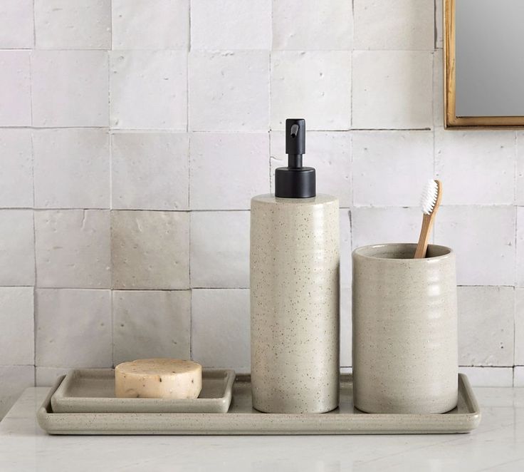 a bathroom set with soap dispenser and toothbrush holder