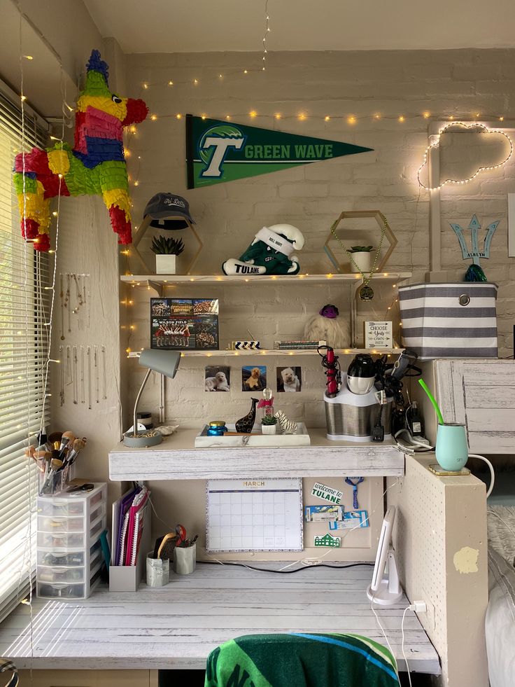 a desk with lots of clutter on top of it and lights hanging from the ceiling