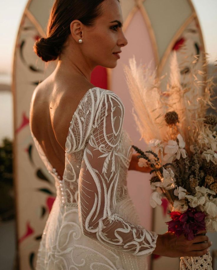 An absolute masterpiece, a lace transparent dress Toba is a perfect choice for your wedding, and here is why. The dress is with an open back, and a beautiful row of pearly buttons. Long sleeves are see-through to the skin, creating this effect of lace curved on your body, the upper bodice is continued from sleeves with the idea of showing your skin and lace surrounding you like an ivy. Elegant pearly waist bend accents your hourglass body, making you look very feminine. Long skirt flutters down, Sheer Bodice Backless Wedding Dress, Elegant Tulle Wedding Dress With Lace Sleeves, Long Sleeve Lace Gown With Illusion Neckline, Wedding Gown With Sheer Back And Fitted Bodice, Tulle Wedding Gown With Sheer Back, Ceremony Gown With Long Lace Sleeves, Long Sleeve Dresses With Sheer Sleeves For Ceremony, Wedding Gown With Lace Sleeves, Long Sleeve Wedding Dress With Sheer Bodice