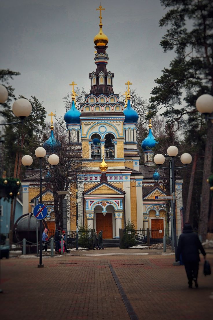 a church with blue and yellow domes on it