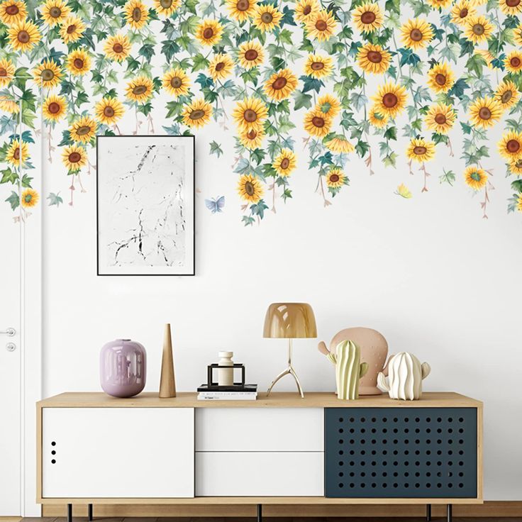 a living room with sunflowers painted on the wall