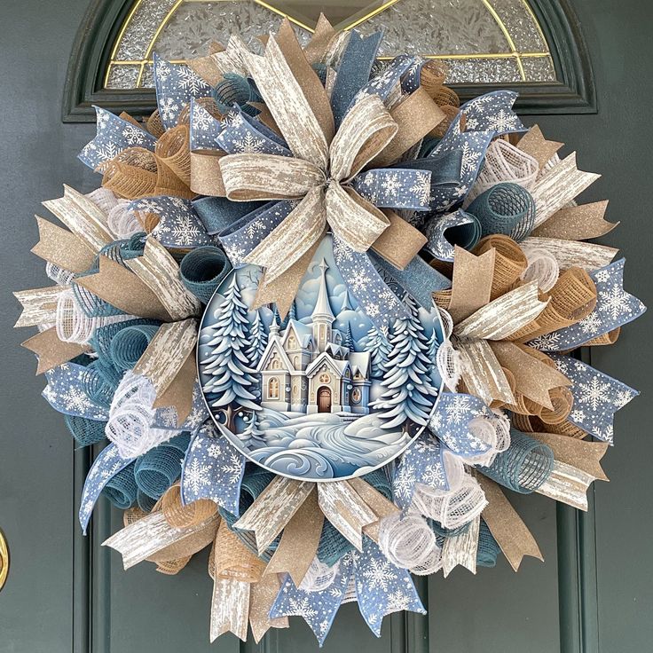 a blue and white christmas wreath hanging on a door