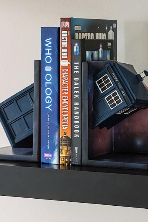 some books are stacked on top of each other in the shape of a doctor who bookender