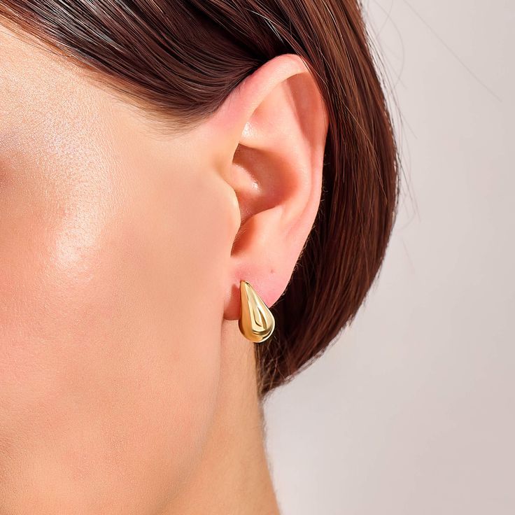 Add a touch of timeless elegance to your look with these Teardrop Earrings. These stunning earrings feature a classic teardrop design that enhances your natural beauty by offering a radiant shine that catches the light with every movement. Perfect for both casual and formal occasions, they are versatile enough to complement any outfit, from a simple day dress to an evening gown. - Made in 14k solid gold - Earring Width: 8.30 mm / 0.32 inches - Thickness: 9.05 mm / 0.35 inches - Length: 14.60 mm / 0.57 inches - This product comes with iconic Norm Jewels gift box Elegant Teardrop Earrings For Everyday, Classic Pear-shaped Gold Earrings, Modern Pear-shaped Earrings For Anniversary, Modern Pear-shaped Earrings For Wedding, Classic Pear-shaped Polished Earrings, Modern Drop Hoop Earrings For Anniversary, Tarnish Resistant Teardrop Hoop Earrings, Elegant Teardrop Earrings For Formal Events, Timeless Teardrop Jewelry For Everyday Elegance