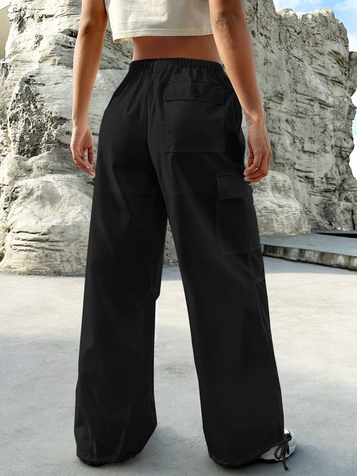 Experience the perfect blend of comfort and style with our Flap Pocket Drop Waist Cargo Pants. These pants are designed for those who appreciate functionality without compromising on fashion. Whether you're exploring the city streets or simply lounging at home, these cargo pants offer versatility for any occasion. Pair them with a casual t-shirt for a laid-back vibe, or dress them up with a button-down shirt for a more polished ensemble. Details: Type: Parachute Pants Closure Type: Drawstring Wa Comfortable Full-length Pants With Pockets, Comfortable Black Bottoms With Pockets, Sporty Wide Leg Trousers With Pockets, Comfortable Black Pants With Pockets, Sporty Wide Leg Pants With Pockets For Fall, Baggy Comfortable Cargo Pants With Pockets, Comfortable Baggy Cargo Pants With Pockets, Comfortable Baggy Cargo Pants, Urban Wide-leg Sweatpants With Pockets