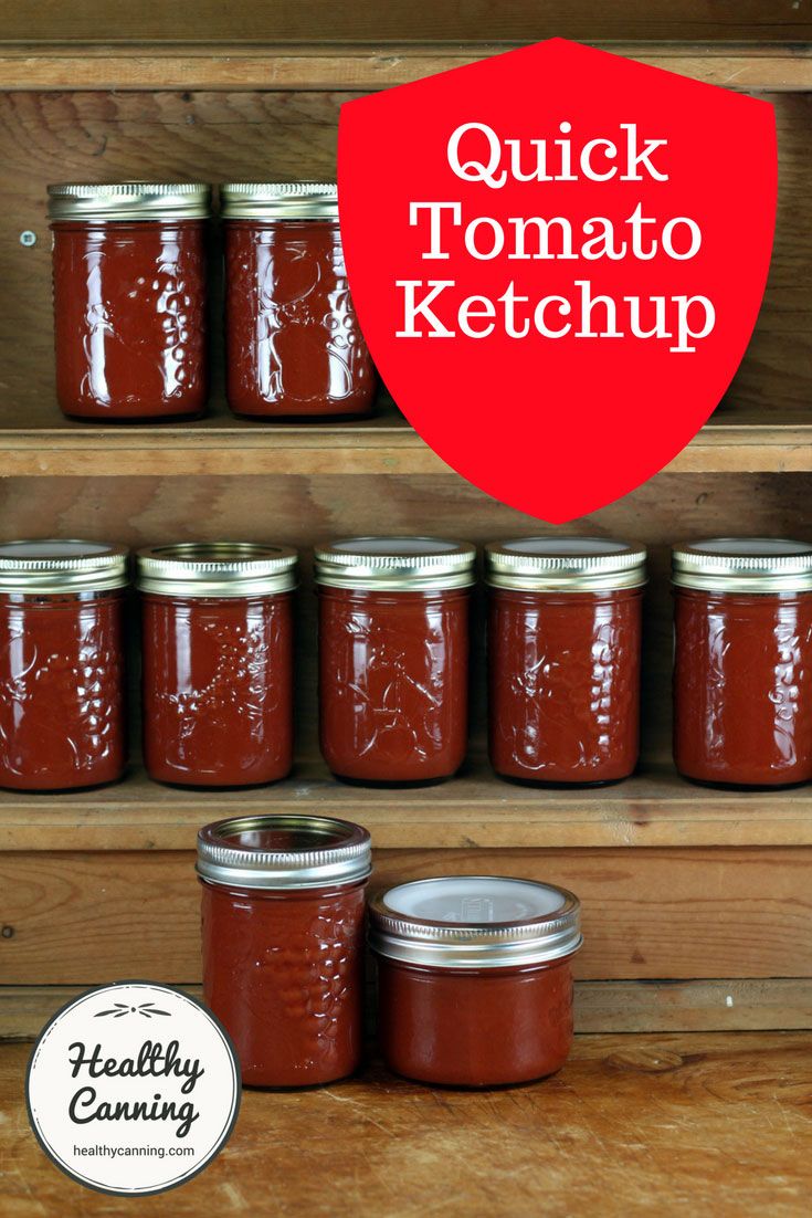 jars filled with tomato ketchup sitting on top of a wooden shelf