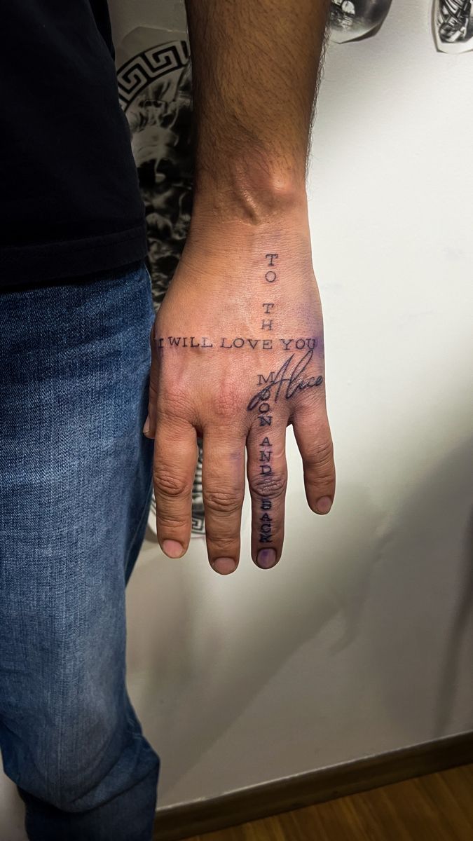 a man's hand with a tattoo on it that says i will love you