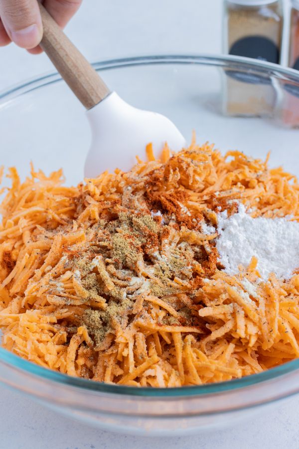 a bowl filled with shredded cheese and spices