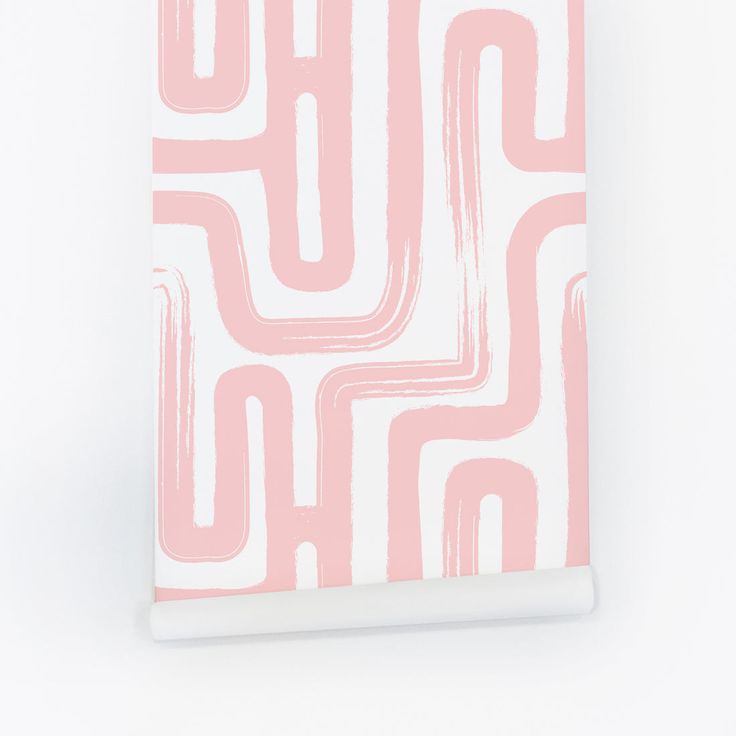 a pink and white notebook with an abstract design