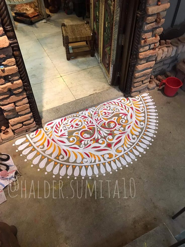 an artistically designed rug is on the ground in front of a storefront door