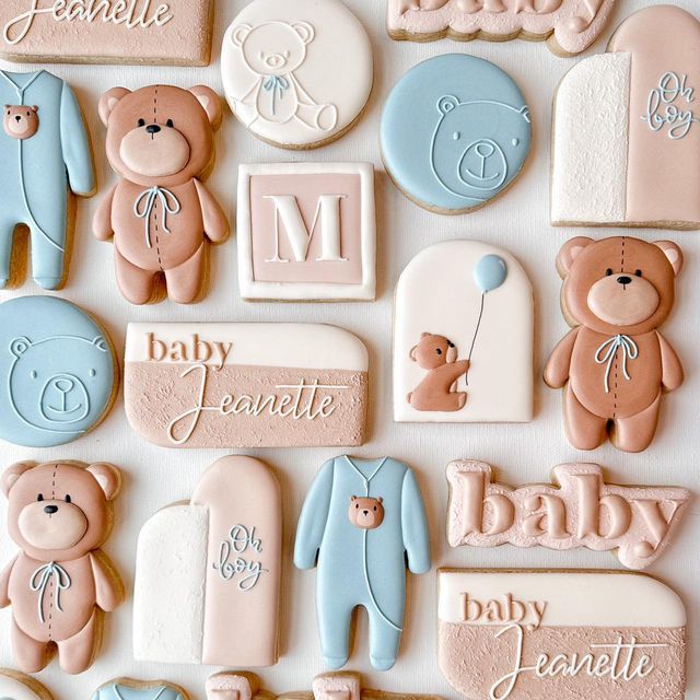 baby shower cookies with teddy bears and name tags on them, all decorated in pastel colors