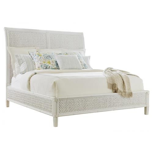 a bed with white wicker headboard and foot board, made in the usa