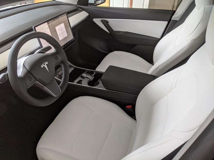 the interior of a modern car with white leather seats and black dash board on display