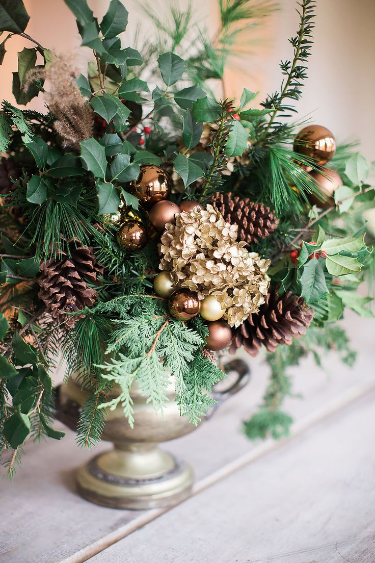 a vase filled with lots of different types of christmas decorations on top of a table