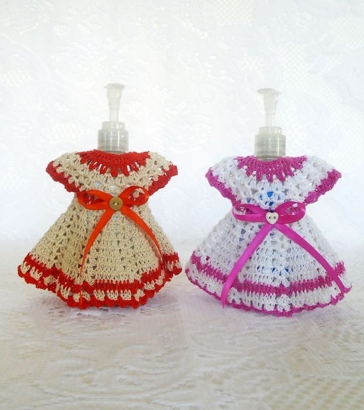 two little bottles that are made to look like crocheted dresses