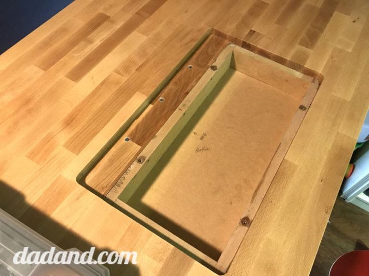 a wooden cutting board sitting on top of a table