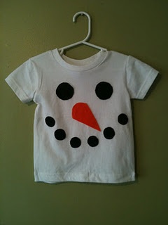 a white t - shirt with a black and red snowman on it hanging from a hook