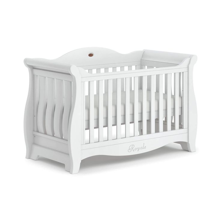 a white baby crib with the word bebe written on it's side