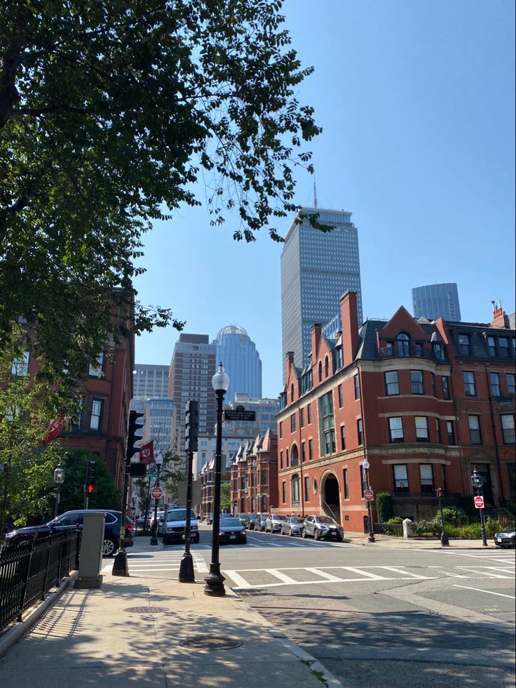 an empty city street with tall buildings in the background