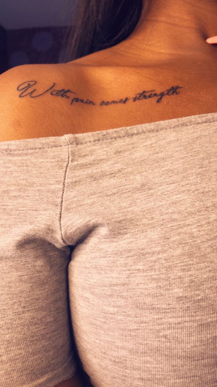 the back of a woman's shoulder with writing on it