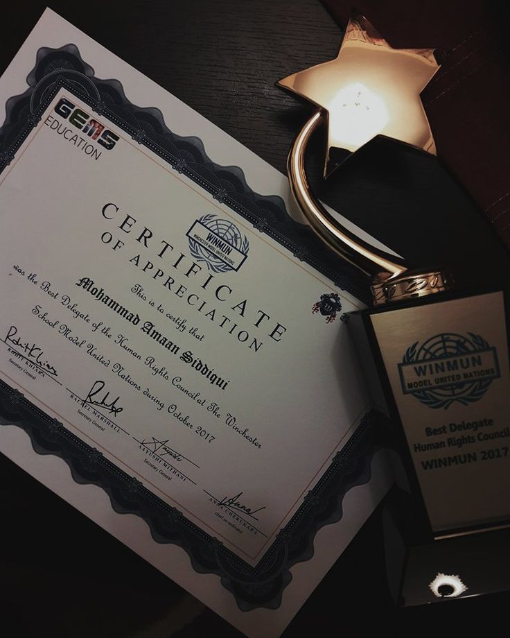 an award is placed on top of a desk next to a lamp and plaque that reads, certificate of appreciation