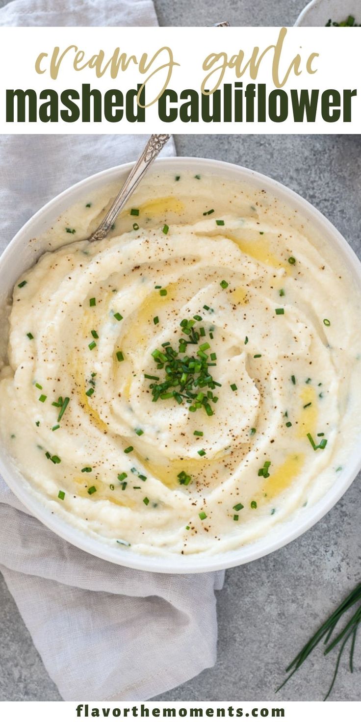 a white bowl filled with mashed cauliflower and topped with parsley on top