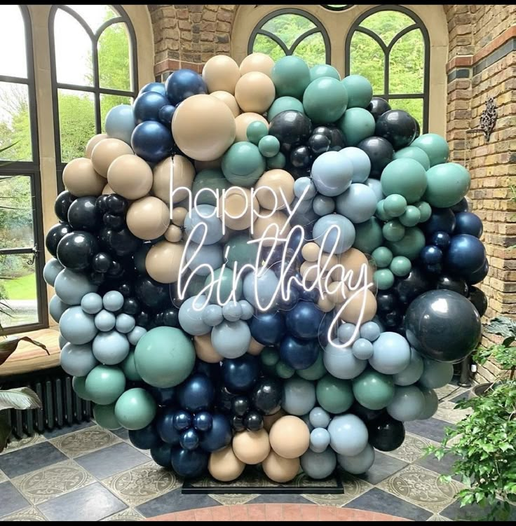 a bunch of balloons that are in the shape of a happy birthday sign on display