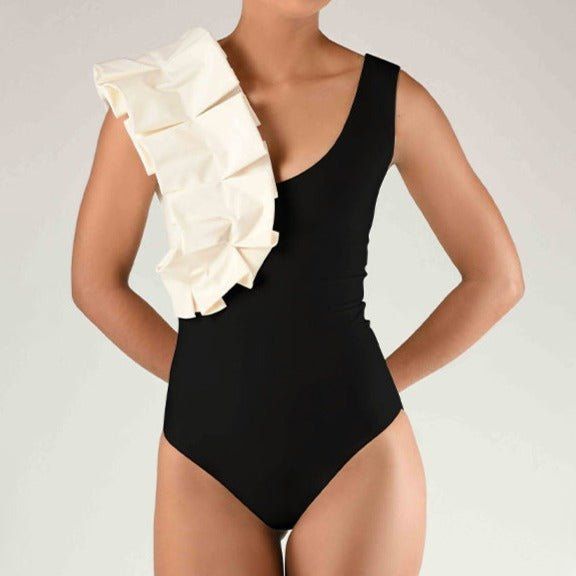 The Joan Ruffle Sleeve One Piece Swimsuit, a chic and stylish swimwear piece that combines contemporary design with romantic details. This elegant one-piece swimsuit features playful ruffle sleeves and a flattering silhouette, perfect for making a statement at any beach or poolside occasion. Designed for those who appreciate a blend of modern fashion and timeless elegance, the Joan swimsuit ensures you look stunning and feel confident while enjoying your time in the sun. Key Features: Ruffle Sleeve Design: Feminine Touch: The ruffle sleeves add a touch of femininity and romantic charm to the swimsuit, creating a unique and eye-catching look. Playful Flair: The playful ruffle details enhance the overall design, making this swimsuit a standout piece in your swimwear collection. Flattering Si Elegant Polyamide Bodysuit For Spring, Chic Stretch Bodysuit For Pool, Chic Stretch Bodysuit For The Pool, Chic One-piece For Sunbathing Beach Season, Stretch Ruffle Bodysuit For Pool, Chic One-pieces For Poolside And Beach Season, Chic One-piece For Poolside And Beach Season, Chic Beachwear One-pieces, Chic One-piece With Ruffles For Poolside