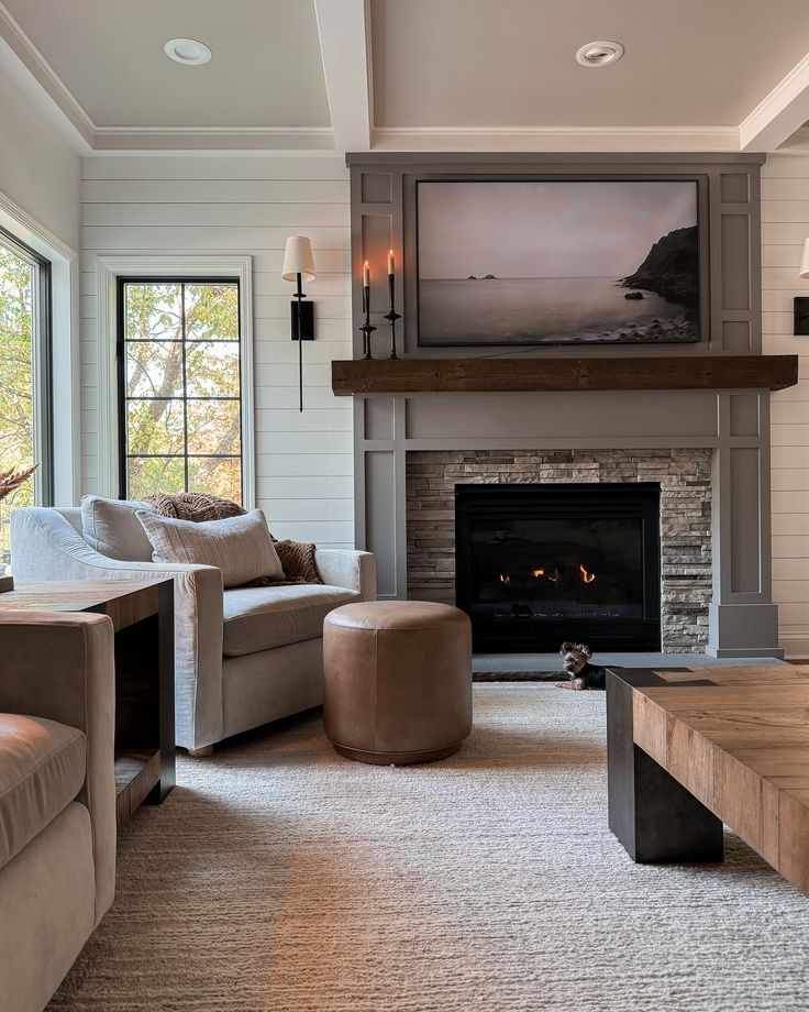 a living room filled with furniture and a fire place in front of a tv mounted above a fireplace