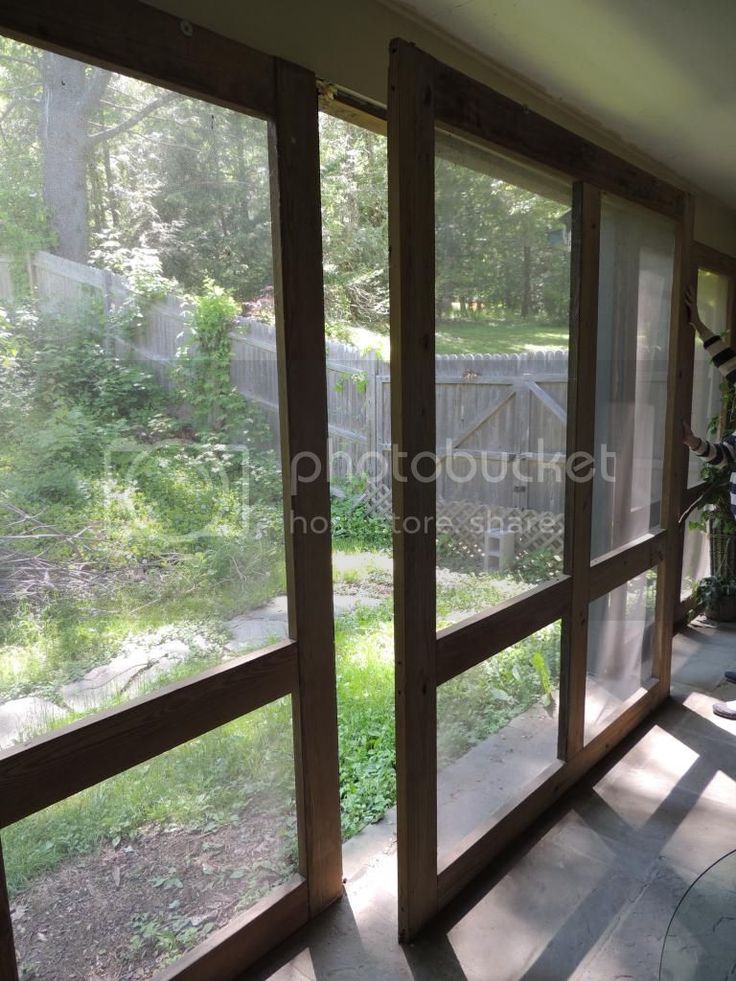 the sun shines through three large windows in an empty room with wood trimming