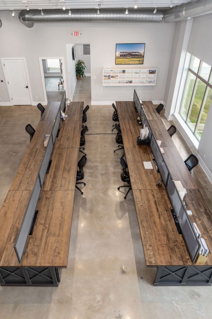 an empty office with wooden desks and chairs