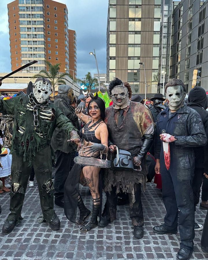 three people dressed up as zombies standing next to each other in front of a truck