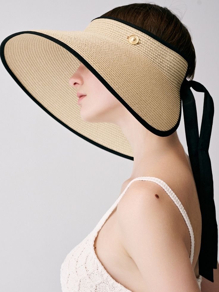 Editor's Notessieor presents unique and stylish hats that add a cute accent to your look. - Made of raffia fabric- Wide and long visor- Strap closure on the back- Vintage button embellished- Classic and trendy mood Measurements (in.)One Size- Visor: 5.12 in.- Depth: 1.97 in.- Circumference: 21.65 ~ 24.41 in. Composition & Care- Material: 100% Raffia- Avoid direct heat and moisture- Natural dry in the shade if wet- Do not bleach- Do not iron- Do not dry clean- Please refer to t Chic Beige Curved Brim Sun Hat, Chic Beige Sun Hat With Curved Brim, Chic Visor Straw Hat With Uv Protection, Chic Visor Sun Hat For Kentucky Derby, Chic Straw Visor Hat With Uv Protection, Chic Straw Visor Hat, Elegant Visor Boater Hat For Vacation, Chic Beige Flat Brim Sun Hat, Elegant Boater Hat With Visor For Vacation