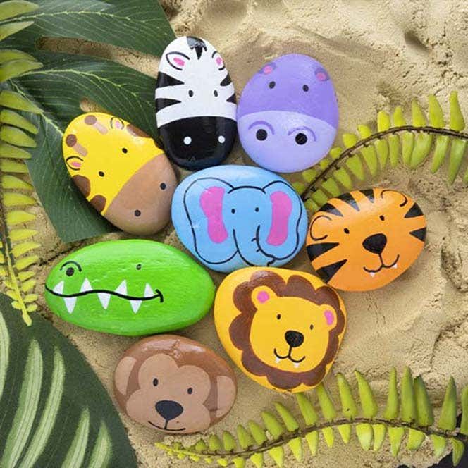 painted rocks with animals and plants in the sand