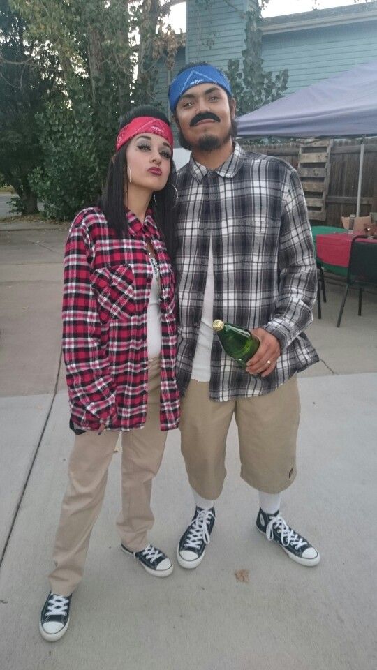 a man and woman are standing next to each other with fake mustaches on their faces