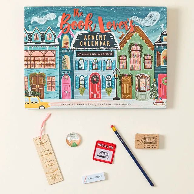 the book lover's adventure calendar with stamps, markers and pencils next to it