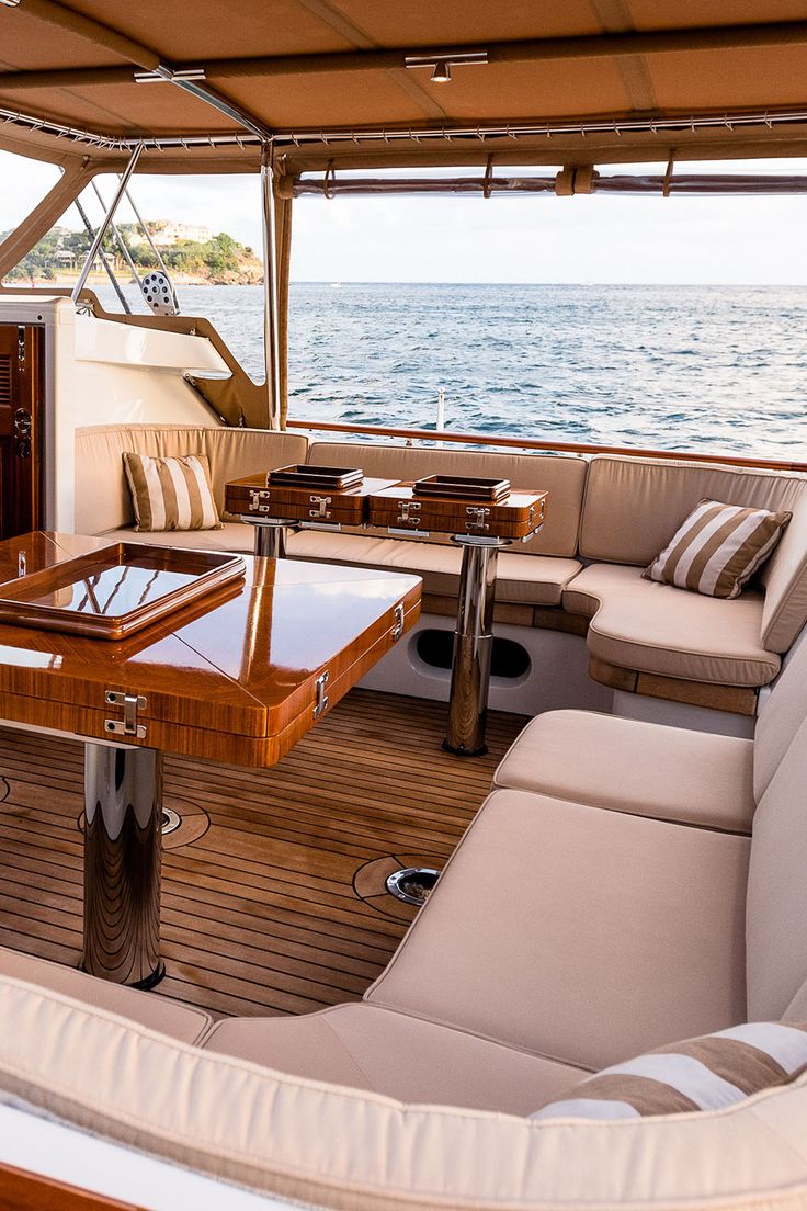 the inside of a boat with couches, tables and chairs on it's deck