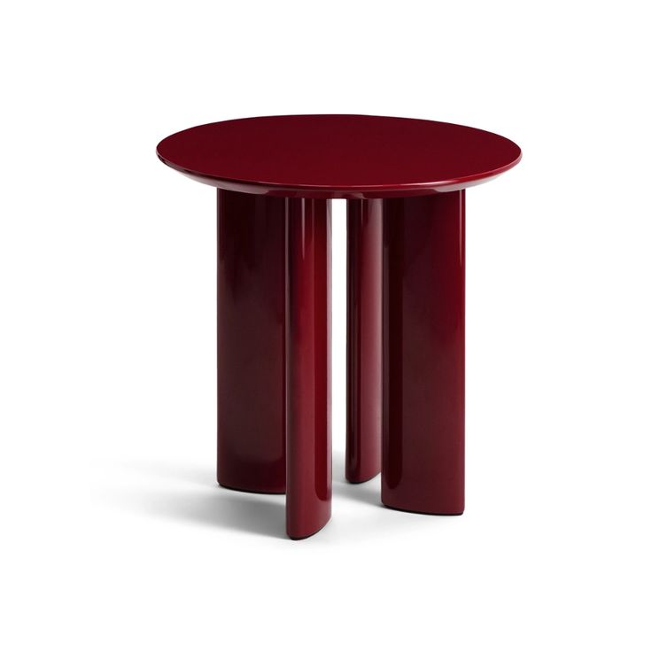 a red table with two legs and a round top on the bottom, in front of a white background