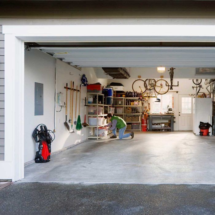 a garage with two men working on the floor