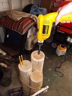 a person using a drill to cut wood