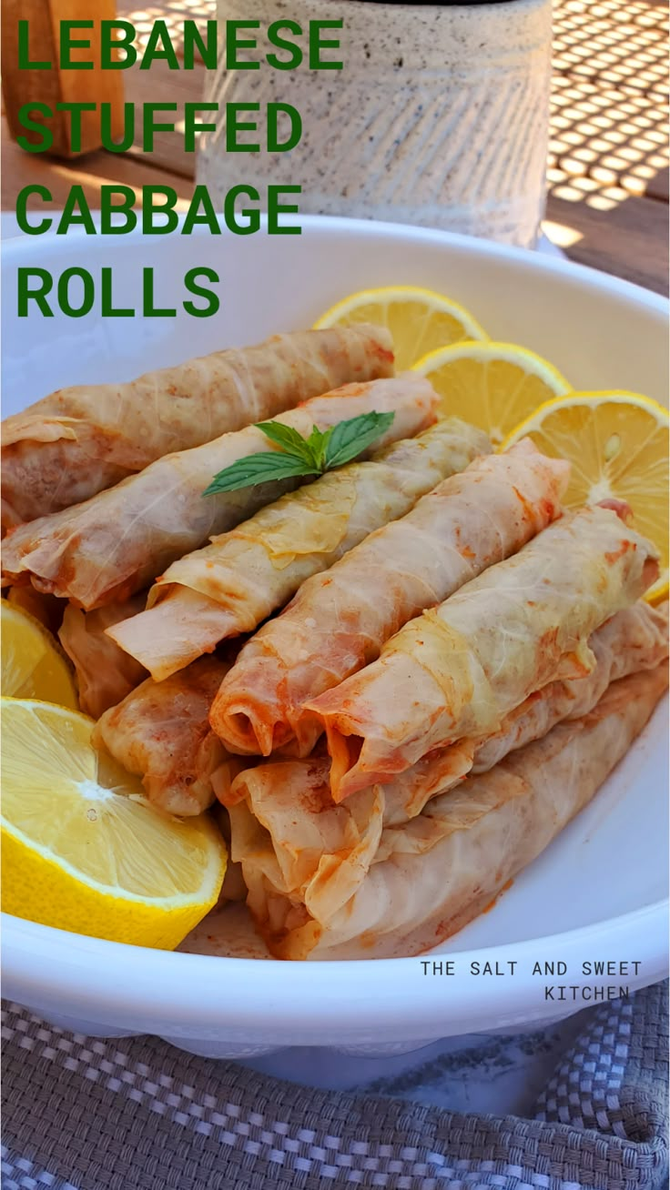 an image of some food in a bowl with lemons and ketchup on the side