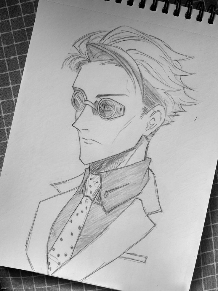 a drawing of a man with glasses and a tie on top of a piece of paper