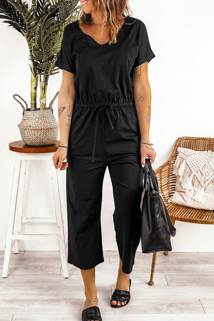 Black V Neck Short Sleeve Jumpsuit Black Relaxed Fit Jumpsuits And Rompers For Loungewear, Black Casual Short Sleeve Jumpsuits And Rompers, Black Solid Color Jumpsuit For Loungewear, Black Solid Color Jumpsuits And Rompers For Loungewear, Black Loungewear Jumpsuits And Rompers, Black V-neck Jumpsuit With Pockets, Black V-neck Jumpsuits And Rompers With Pockets, Black Solid Color Overall Jumpsuit, Black Solid Color Jumpsuits And Rompers