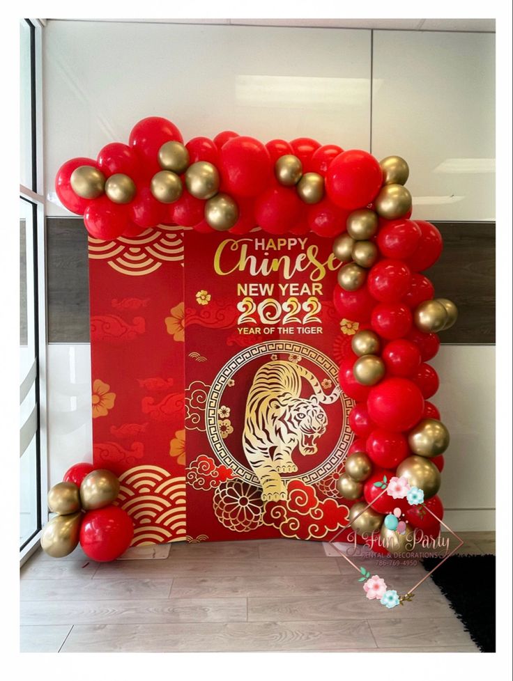 a red and gold chinese new year balloon arch