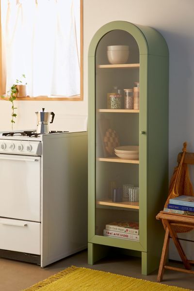 a kitchen with an oven, stove and cabinet in it's corner next to a window